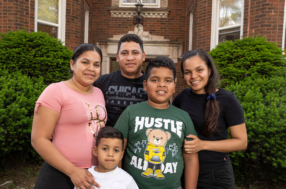 Catherine's Caring Cause WBEZ, family in front of Chicago apartment